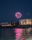 Colorful fireworks on the beach. Kids on the front playing