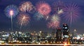 Colorful fireworks on blur city skyline background Royalty Free Stock Photo