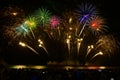 Colorful fireworks celebration and the night sky background with crowded people on the beach