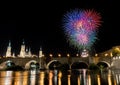 colorful fireworks exploding in the dark night sky creating light and color effects above the bridge and close to Basilica of Royalty Free Stock Photo