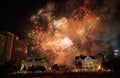 Colorful fireworks exploding over historic buildings and crowd Royalty Free Stock Photo