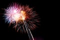 Colorful fireworks infront of a black night sky. The fireworks are a variety of colors, including yellow, purple, pink, orange Royalty Free Stock Photo