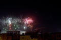 colorful fireworks at night with shadows of a construction site and cranes, festive signs of celebration, anniversary carnival and Royalty Free Stock Photo