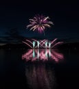 Colorful fireworks with reflection on lake. Royalty Free Stock Photo