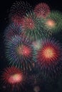 Colorful fireworks of various colors over night sky background. Royalty Free Stock Photo