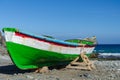 Colorful fishing boat on the beach at the Atlantic Ocean Royalty Free Stock Photo