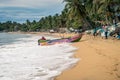 Colorful fishing boat beaching on a sri lankan beach, Arugam bay, Sri lanka