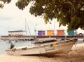 Colorful fishing boat, dock, beach and fishing huts along boardwalk Royalty Free Stock Photo
