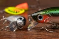 Colorful fishing lures, wobbler, spinner, on wood desk different fishing baits