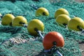 Colorful fishing net laying on a pier, closeup photo with selective focus and blurred background Royalty Free Stock Photo