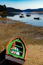 Colorful fishing row boat ashore with low tide. Royalty Free Stock Photo