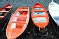 Colorful fishing wooden boat moored on the beach - coral color