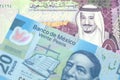 A Saudi five riyal bank note with a twenty Mexican peso bank note