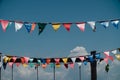 Colorful flags bunting against blue sky. Royalty Free Stock Photo