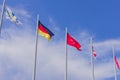Colorful flags from different countries waving on blue sky background Royalty Free Stock Photo