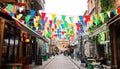 Colorful flags in a street in a Greek town Royalty Free Stock Photo
