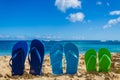 Colorful flip flops on the sandy beach