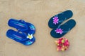 Colorful flip flops on the sandy beach. Male and female slippers Royalty Free Stock Photo