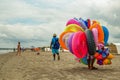 A colorful floater salesman walking on a beach