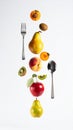 Colorful Floating Fruit Arrangement with Silverware on White Backdrop Still Life Royalty Free Stock Photo