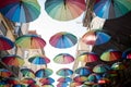 Colorful floating umbrellas hang above the street Royalty Free Stock Photo
