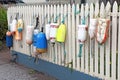 Colorful floats and buoys hanging from a fence