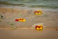 Colorful floral offerings thrown in the sea in India