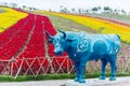 Colorful flower blossoming in the field with fence and blue sculpture