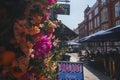 Colorful flower decoration outside shop in townsquare during sunny day