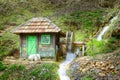 Wooden little water mill and motion blur wheel Royalty Free Stock Photo