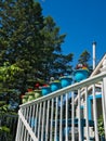 Colorful flower pots on a white balcony railing Royalty Free Stock Photo