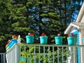 Colorful flower pots on a white balcony railing Royalty Free Stock Photo