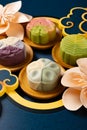 colorful flower shape snowy mooncakes with Chinese decorations at vertical composition Royalty Free Stock Photo