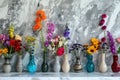 Colorful flowers in assorted glass vases on marble background Royalty Free Stock Photo