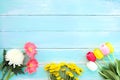 Colorful flowers bouquet on blue wooden background.