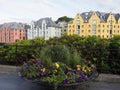 Colorful flowers and buildings of european Alesund town and yacht at Romsdal region in Norway Royalty Free Stock Photo