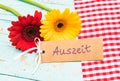 Colorful flowers and gift card with german word, Auszeit, means timeout or relax Royalty Free Stock Photo