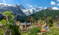 Colorful flowers ornate an old graveyard under the beautiful French mountains. Royalty Free Stock Photo