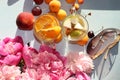 Colorful flowers of pink peony on a wooden table, summer drinks and various fruits, top view with copy space, selective focus Royalty Free Stock Photo