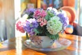 Colorful flowers are placed in the pot size cute table with the