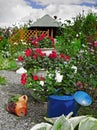 Colorful flowers in pots in the garden. Garden shed surrounded by colorful potted plants and shrubs. Royalty Free Stock Photo