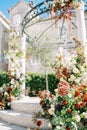 Colorful flowers on the steps and columns of a wedding rotunda in the garden Royalty Free Stock Photo