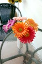Colorful flowers in a vase on the table. Royalty Free Stock Photo