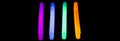 Colorful fluorescent light neon big glow stick on mirror reflection black background