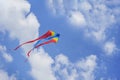 Colorful flying kite flying in sky with clouds Royalty Free Stock Photo