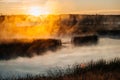 Colorful fog over the lake in autumn at dawn