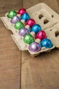 Colorful foiled eggs in container