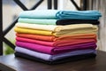 colorful folded towels on a metal rack