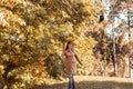 Colorful foliage in the park. Falling leaves natural background. Happy red hair woman in nature Royalty Free Stock Photo