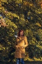 Colorful foliage in the park. Falling leaves natural background. Red hair woman in nature Royalty Free Stock Photo